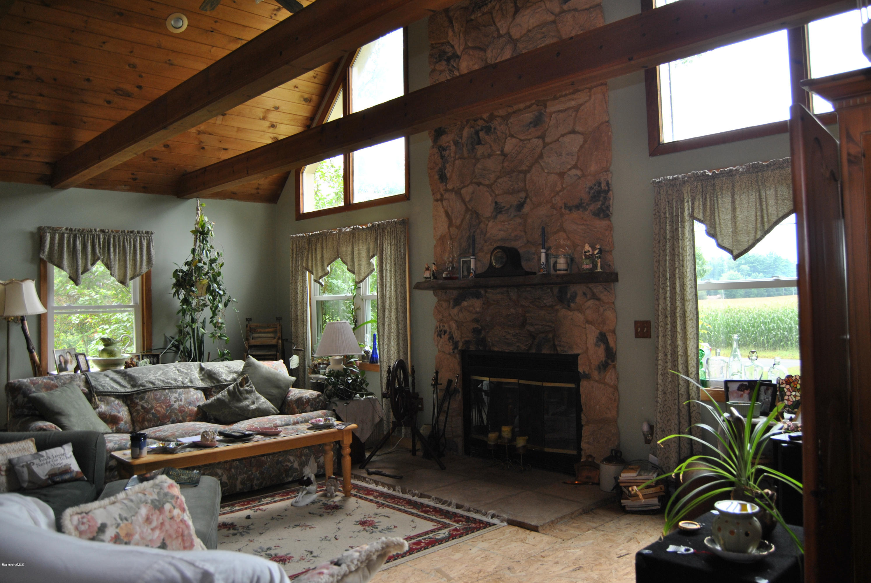 48 Alum Hill Road New Marlborough, MA 01259 - Photo 2 of 19 a living room with furniture a window and a fireplace