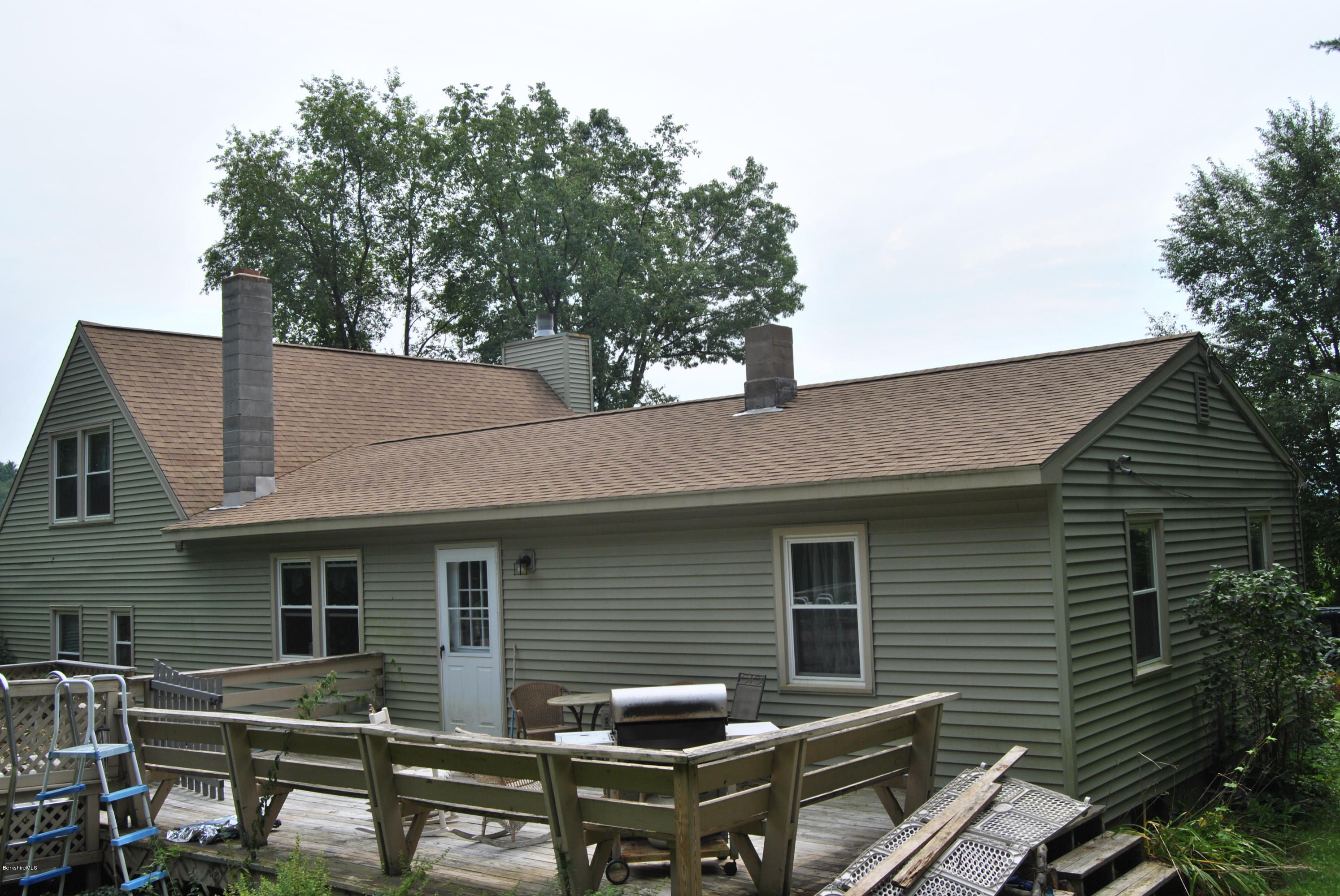 48 Alum Hill Road New Marlborough, MA 01259 - Photo 18 of 19 a backyard of a house with table and chairs