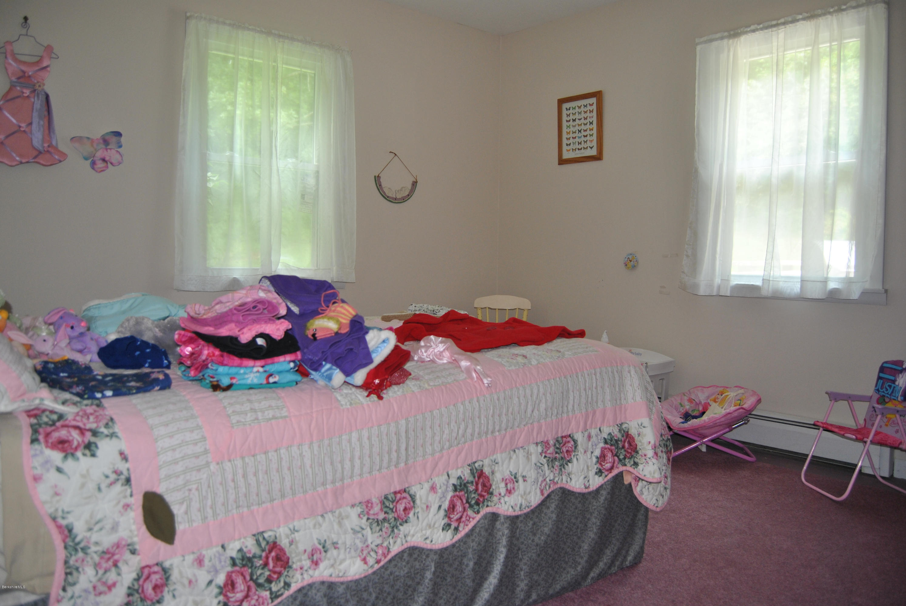 48 Alum Hill Road New Marlborough, MA 01259 - Photo 8 of 19 a bedroom with a bed that has a blanket and a chair in it