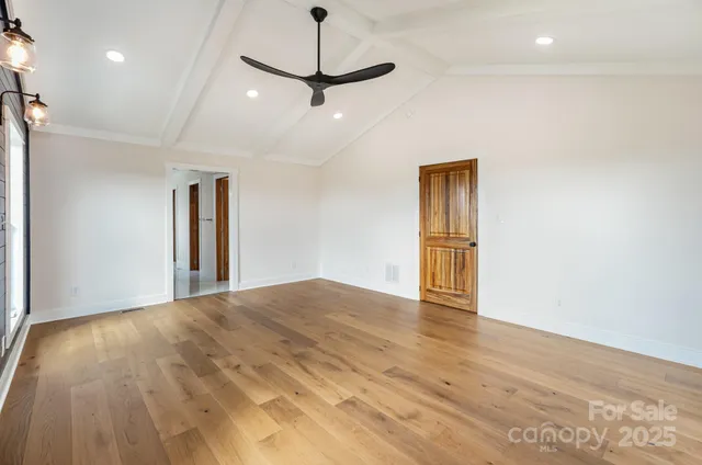 a bedroom with a large bed and a flat screen tv