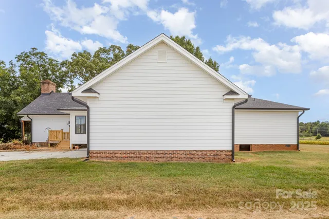 a front view of a house with a garden and yard