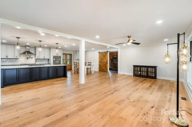 a view of a kitchen with a sink and a refrigerator