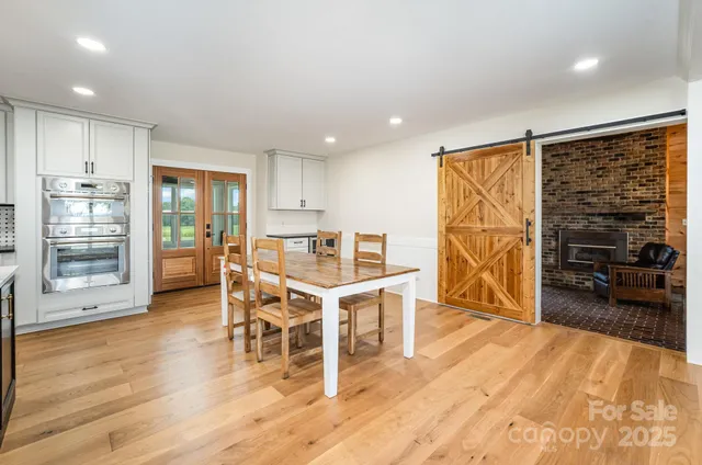 a view of a kitchen with furniture and wooden floor
