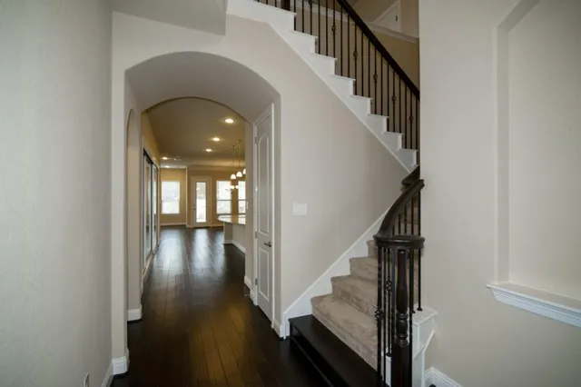 a view of entryway and hall with wooden floor