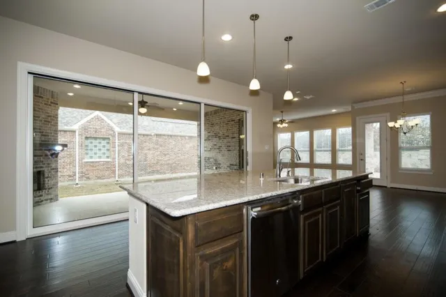 a kitchen with a sink and large windows