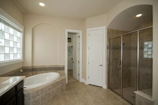 a spacious bathroom with a shower tub and sink