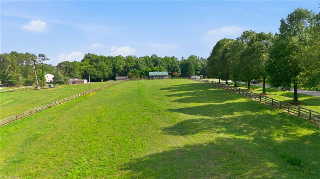 8861 Boylston Road Colfax, NC 27235 - Photo 45 of 50 Wide-open fenced pasture provides plenty of space for grazing, turnout, or expanding your equestrian operation.