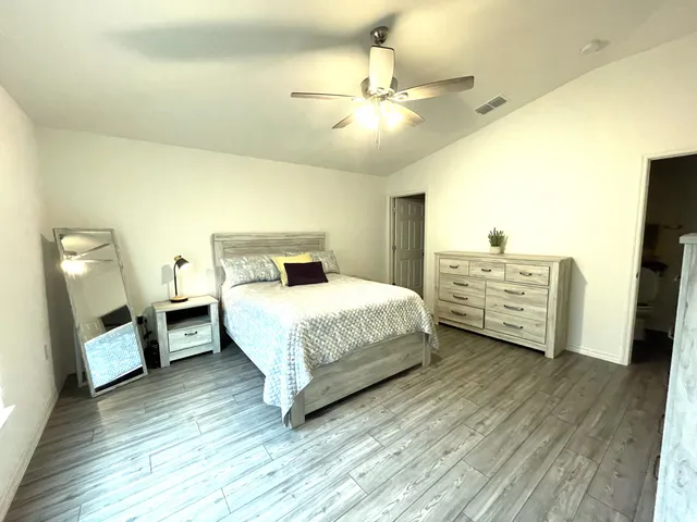 a kitchen with a sink a counter space and wooden floor