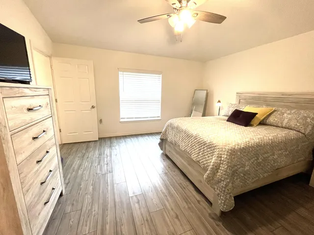 a bedroom with a bed and a chandelier