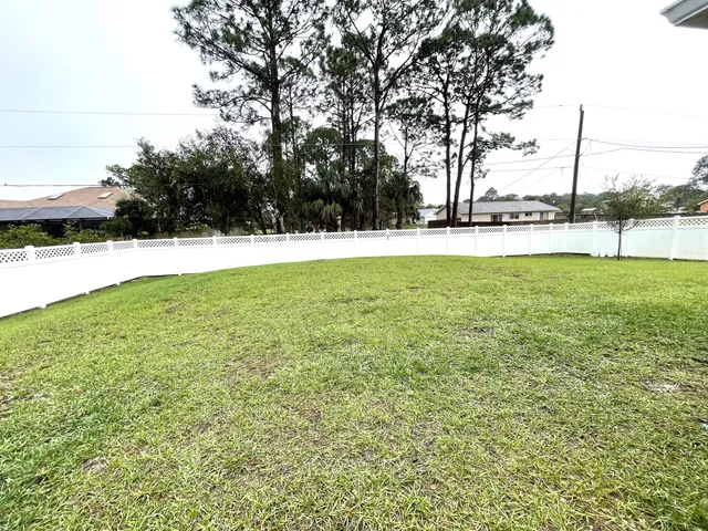 a living room with patio furniture and a large window
