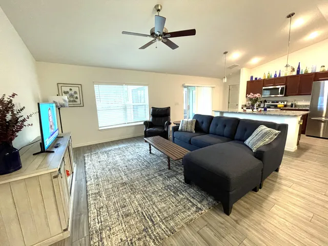 a living room with furniture and wooden floor