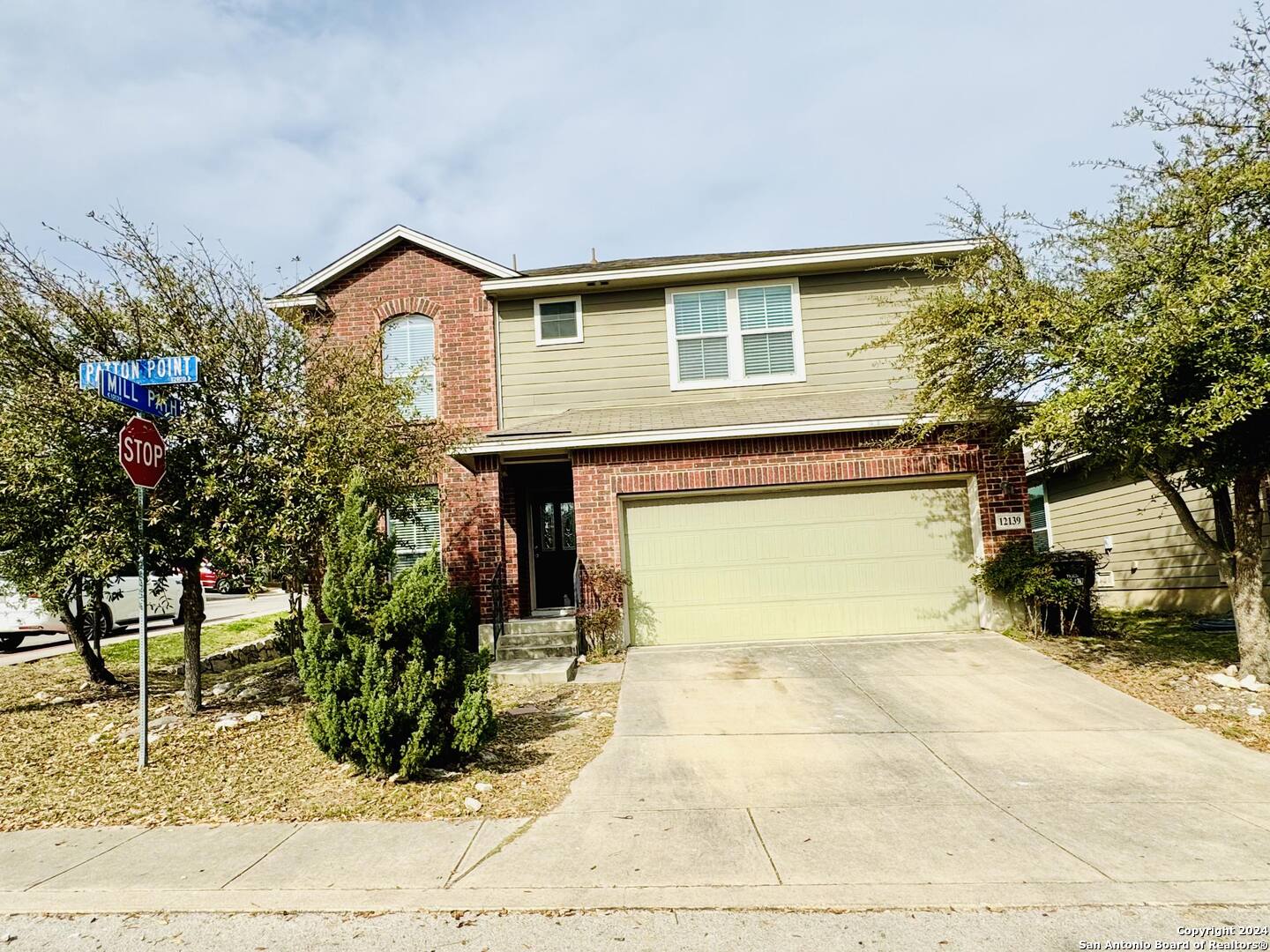 12139 Patton Point San Antonio, TX 78254 - Photo 2 of 34 a front view of a house with garden
