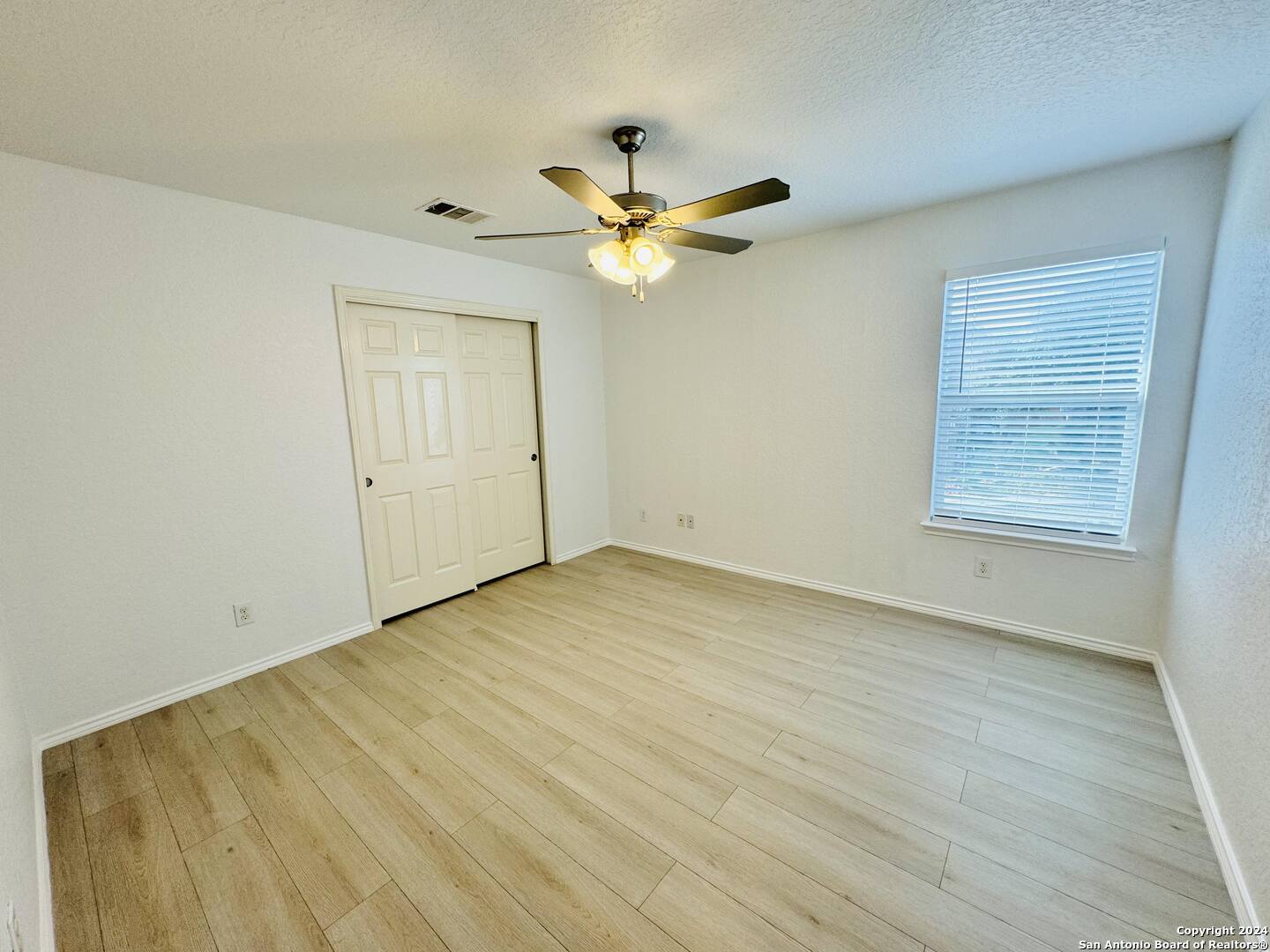 12139 Patton Point San Antonio, TX 78254 - Photo 21 of 34 an empty room with a window and a ceiling fan