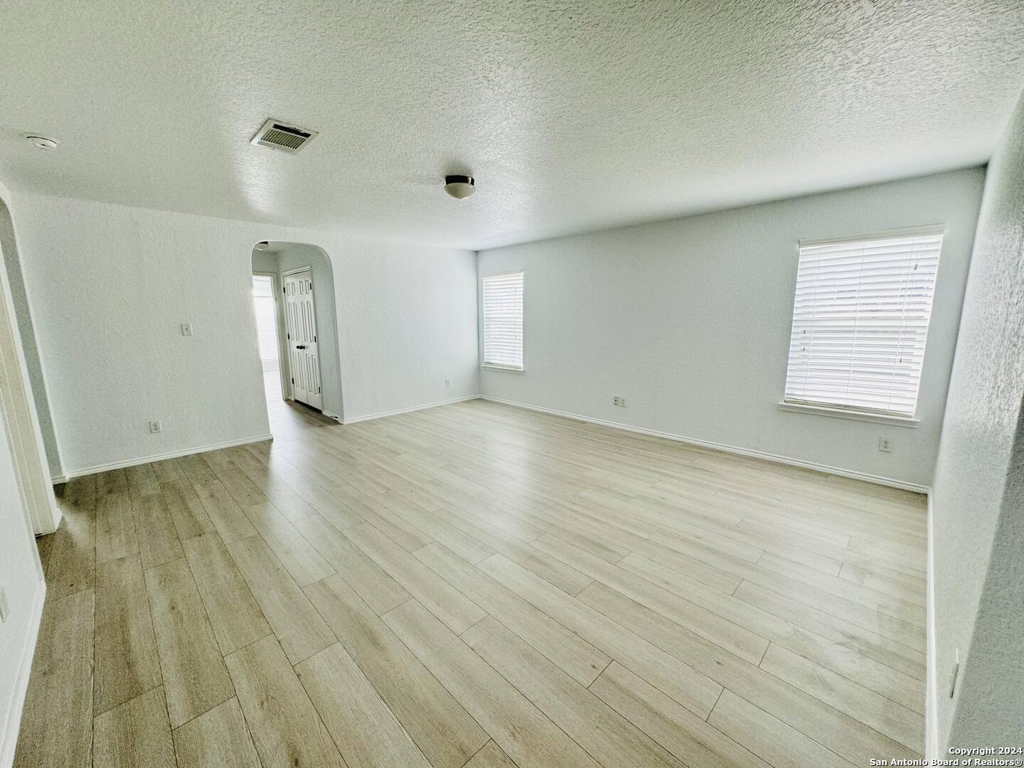 12139 Patton Point San Antonio, TX 78254 - Photo 22 of 34 an empty room with wooden floor and windows