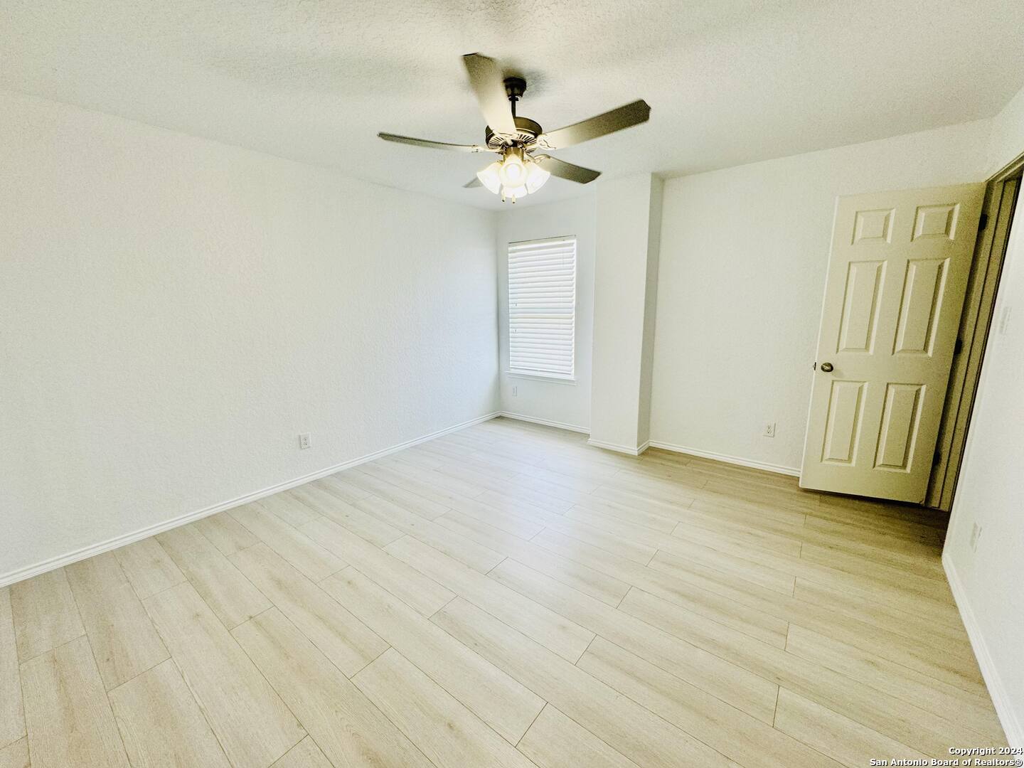 12139 Patton Point San Antonio, TX 78254 - Photo 25 of 34 a view of a room with wooden floor and a ceiling fan