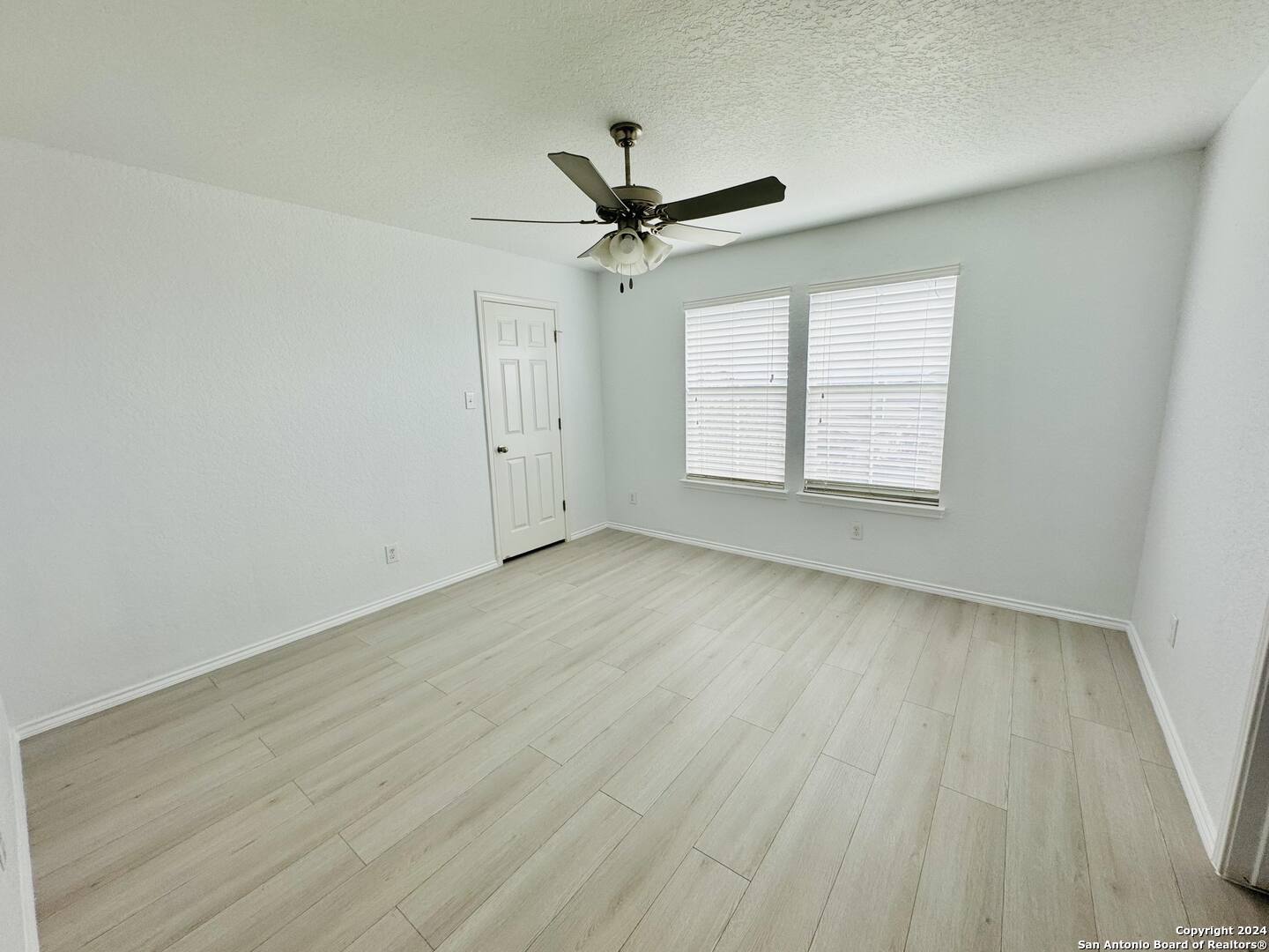 12139 Patton Point San Antonio, TX 78254 - Photo 26 of 34 wooden floor in an empty room with a window