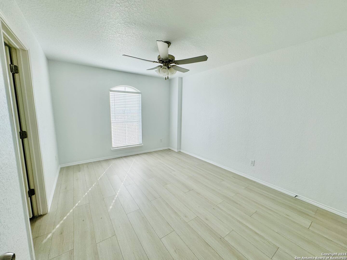 12139 Patton Point San Antonio, TX 78254 - Photo 27 of 34 an empty room with windows and fan