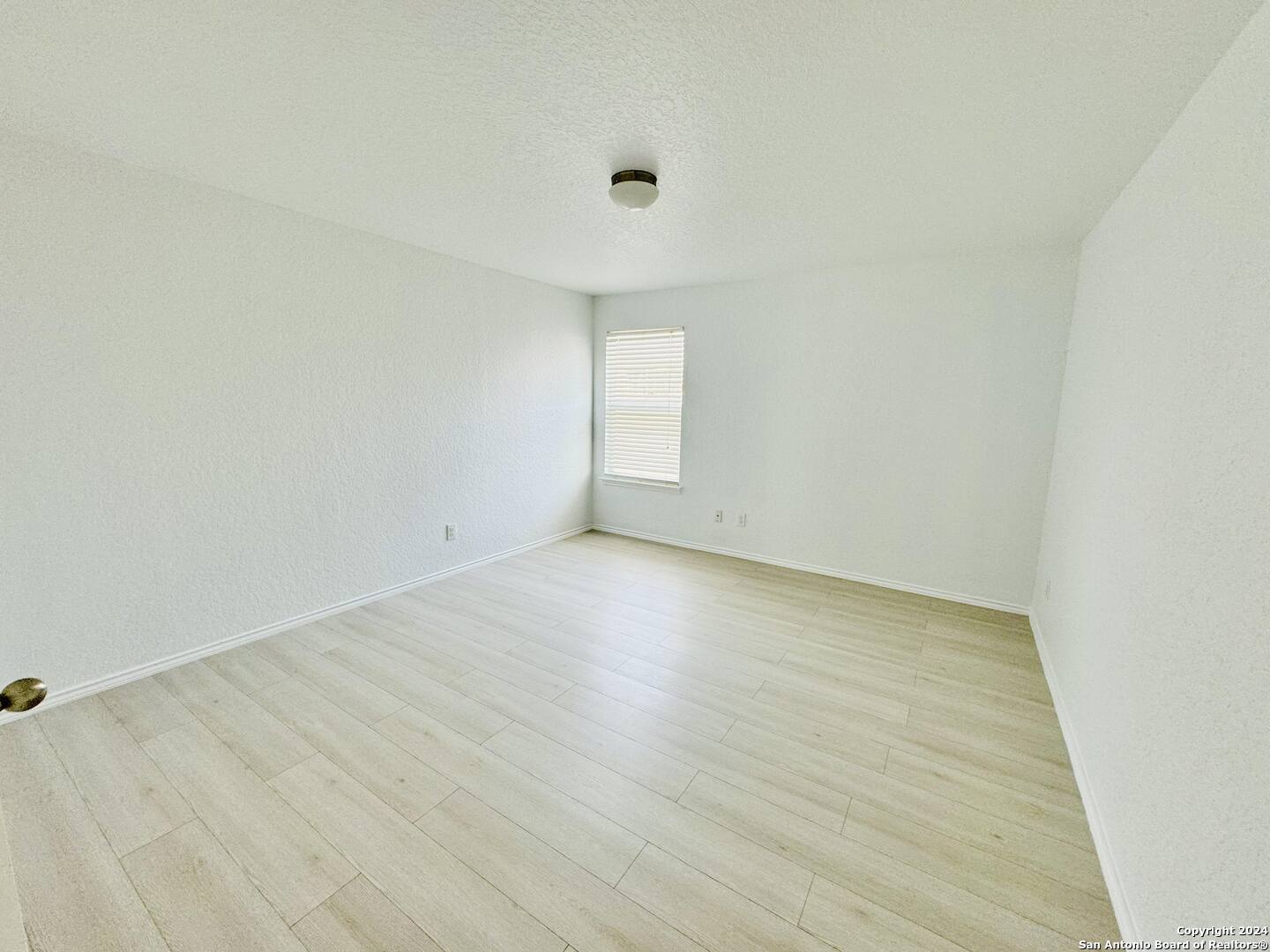 12139 Patton Point San Antonio, TX 78254 - Photo 28 of 34 an empty room with wooden floor and windows