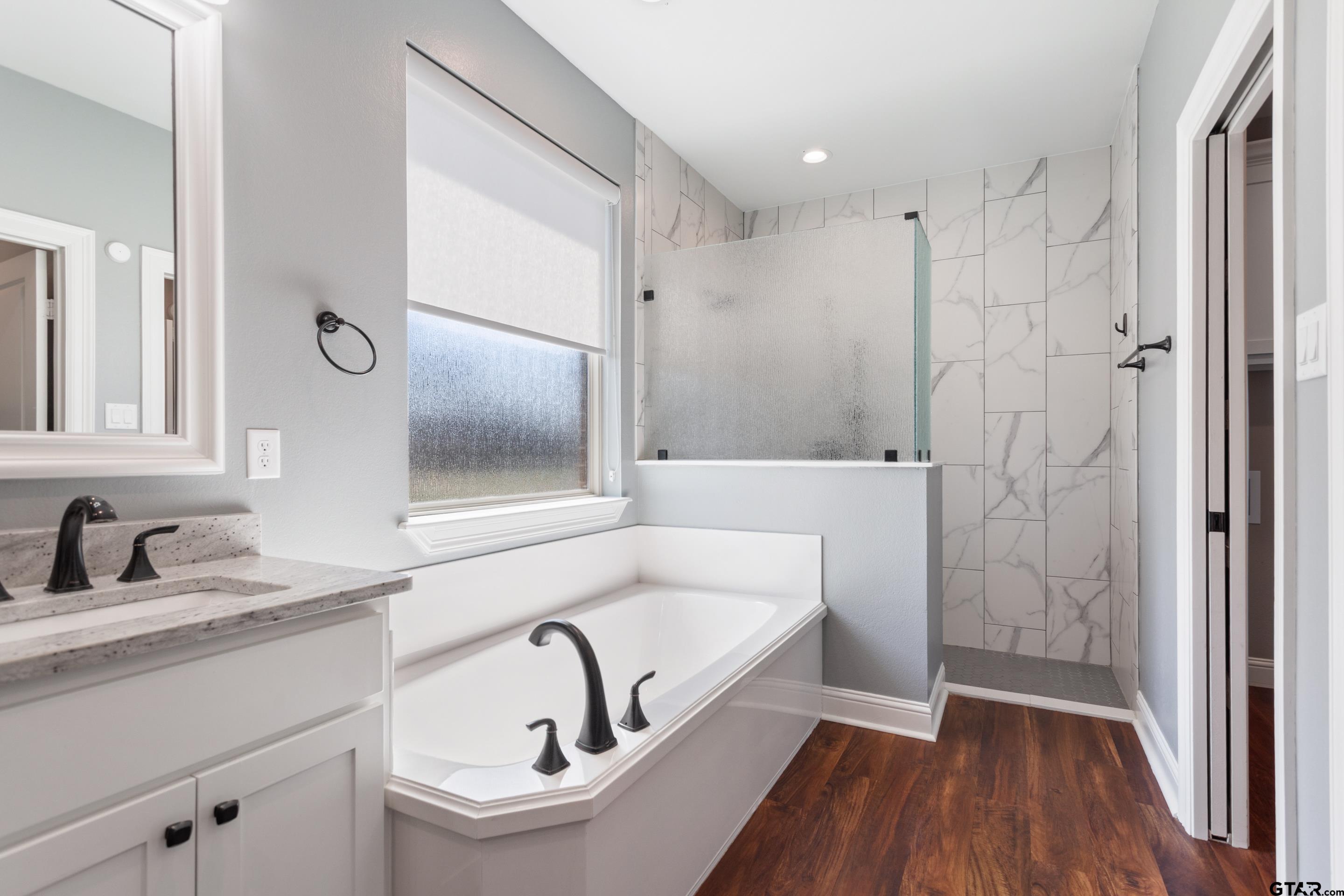 105 Nathan Road Chandler, TX 75758 - Photo 19 of 36 a bathroom with a sink and a mirror