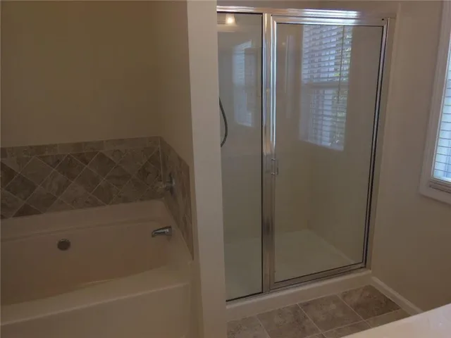 a bathroom with a glass shower door