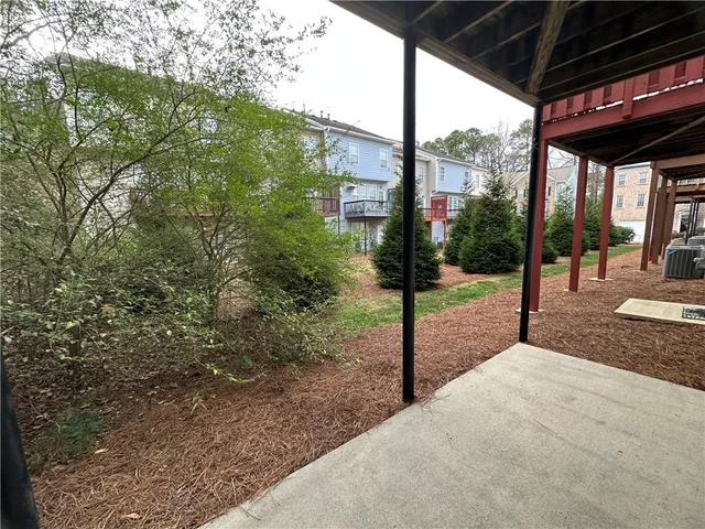a view of a house with backyard and porch