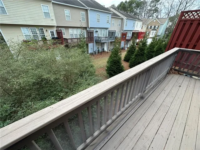a balcony with wooden floor and outdoor space