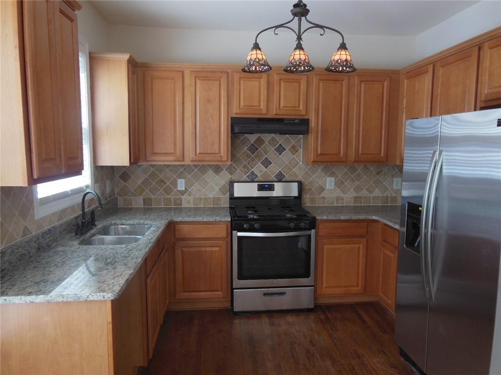 2970 Wintercrest Trace Atlanta, GA 30360 - Photo 6 of 15 a kitchen with stainless steel appliances granite countertop a sink a stove a refrigerator and cabinets