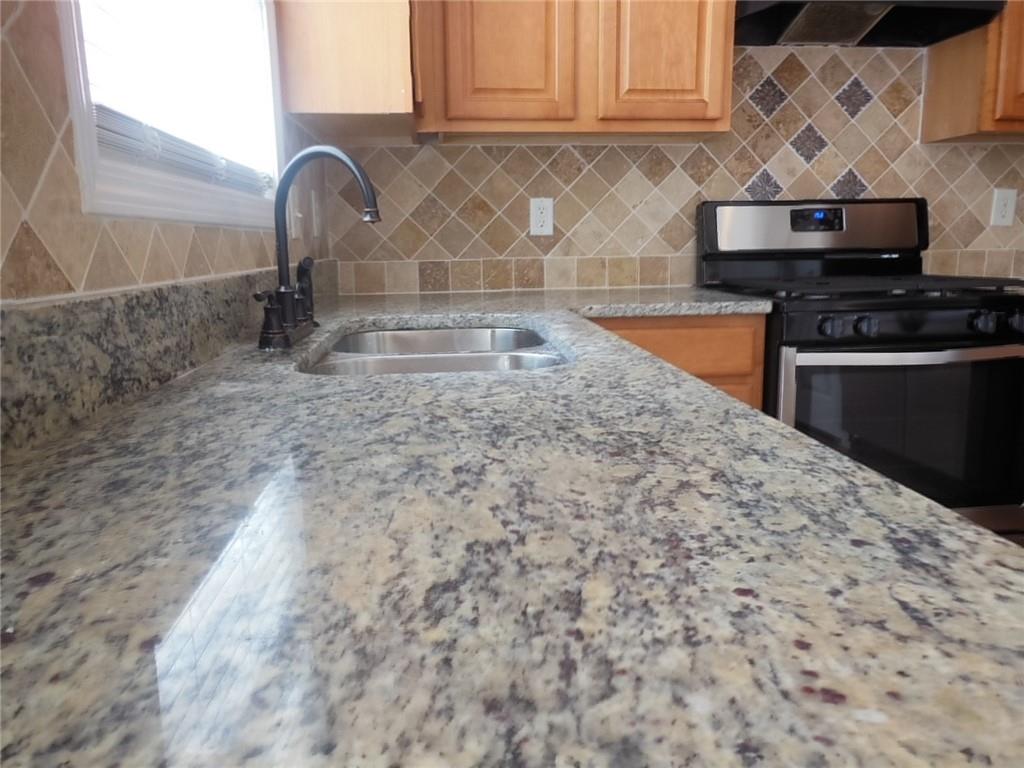 2970 Wintercrest Trace Atlanta, GA 30360 - Photo 8 of 15 a kitchen with granite countertop a sink stainless steel appliances and cabinets