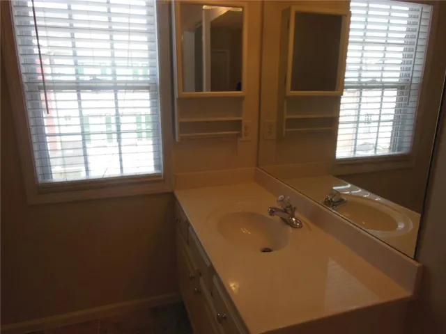 a bathroom with a sink and a window