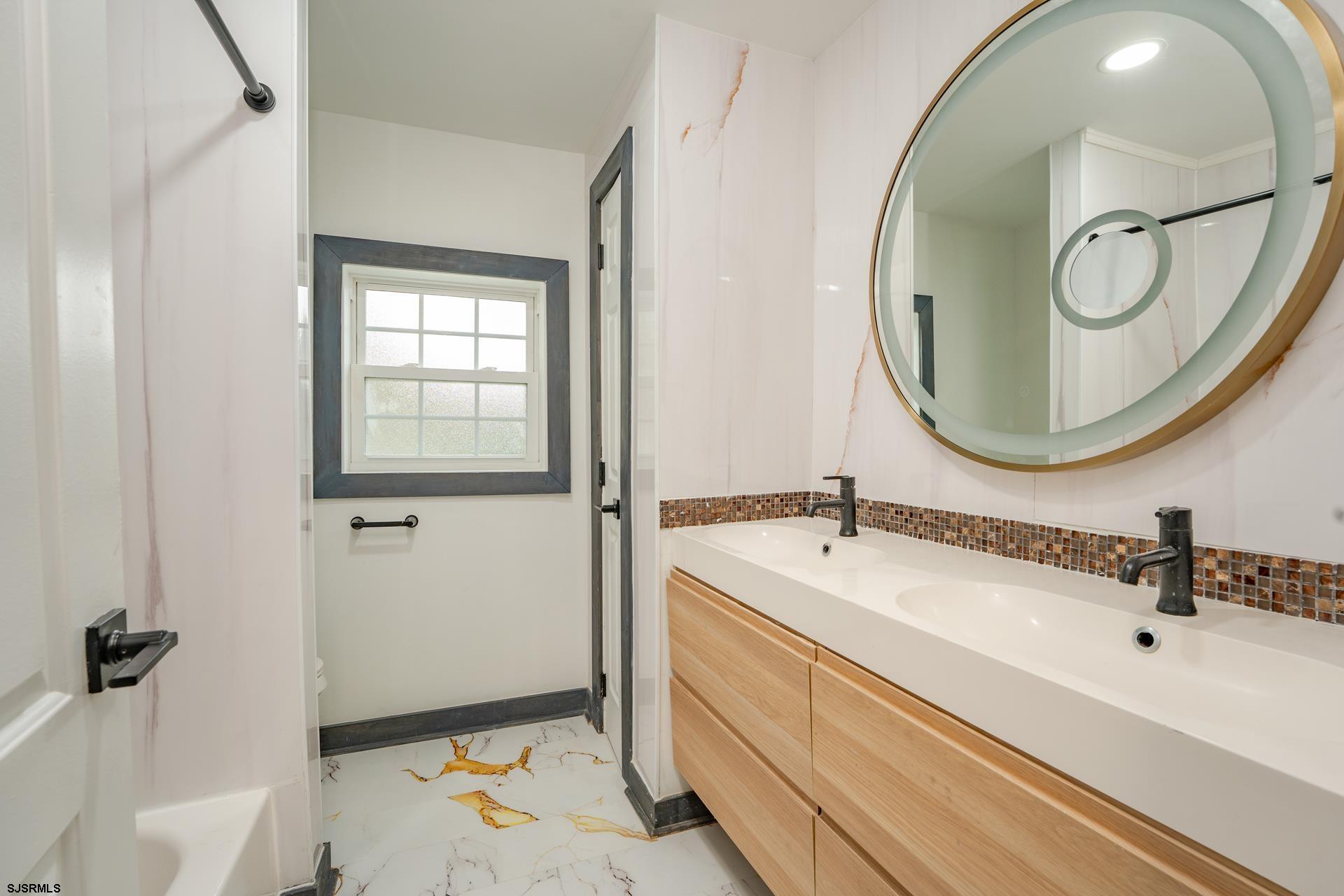 1203 West Mill Road Northfield, NJ 08225 - Photo 25 of 90 a bathroom with a sink and a mirror