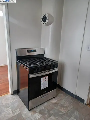 a stove top oven sitting inside of a kitchen