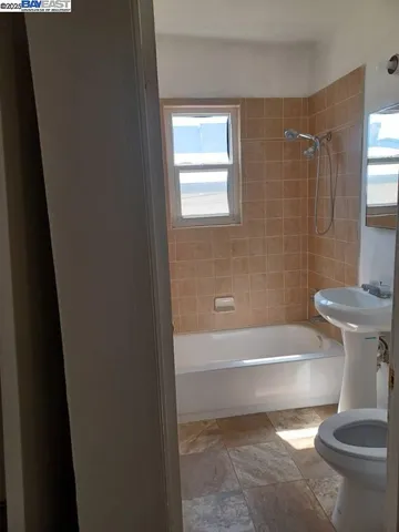a bathroom with a bathtub and a toilet