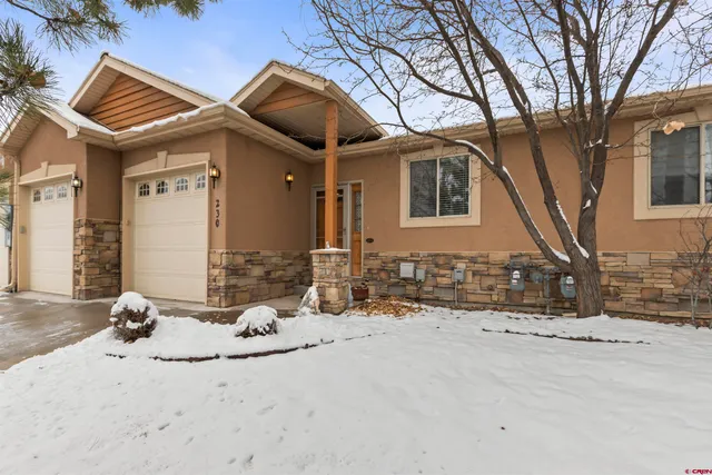 a view of a house with snow on the road