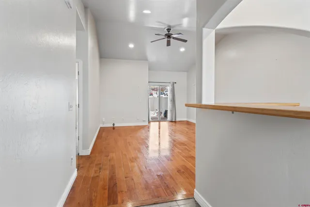 a view of empty room with wooden floor