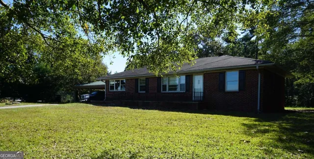 a front view of a house with a yard