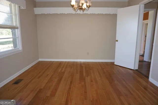 a view of walk in closet with wooden floor and fan