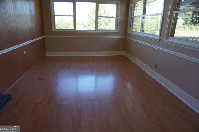a view of a small space with wooden floor and staircase