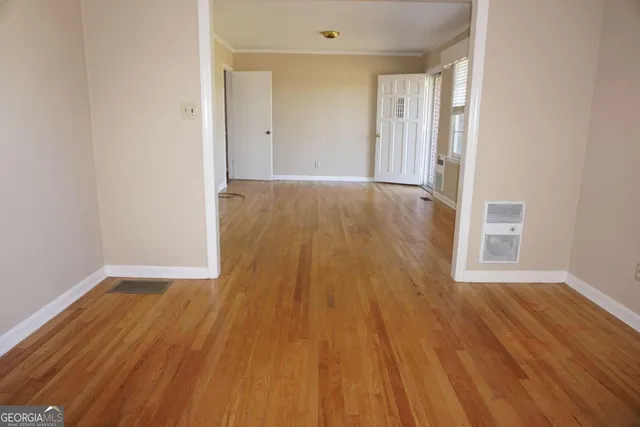 a view of a hallway with wooden floor