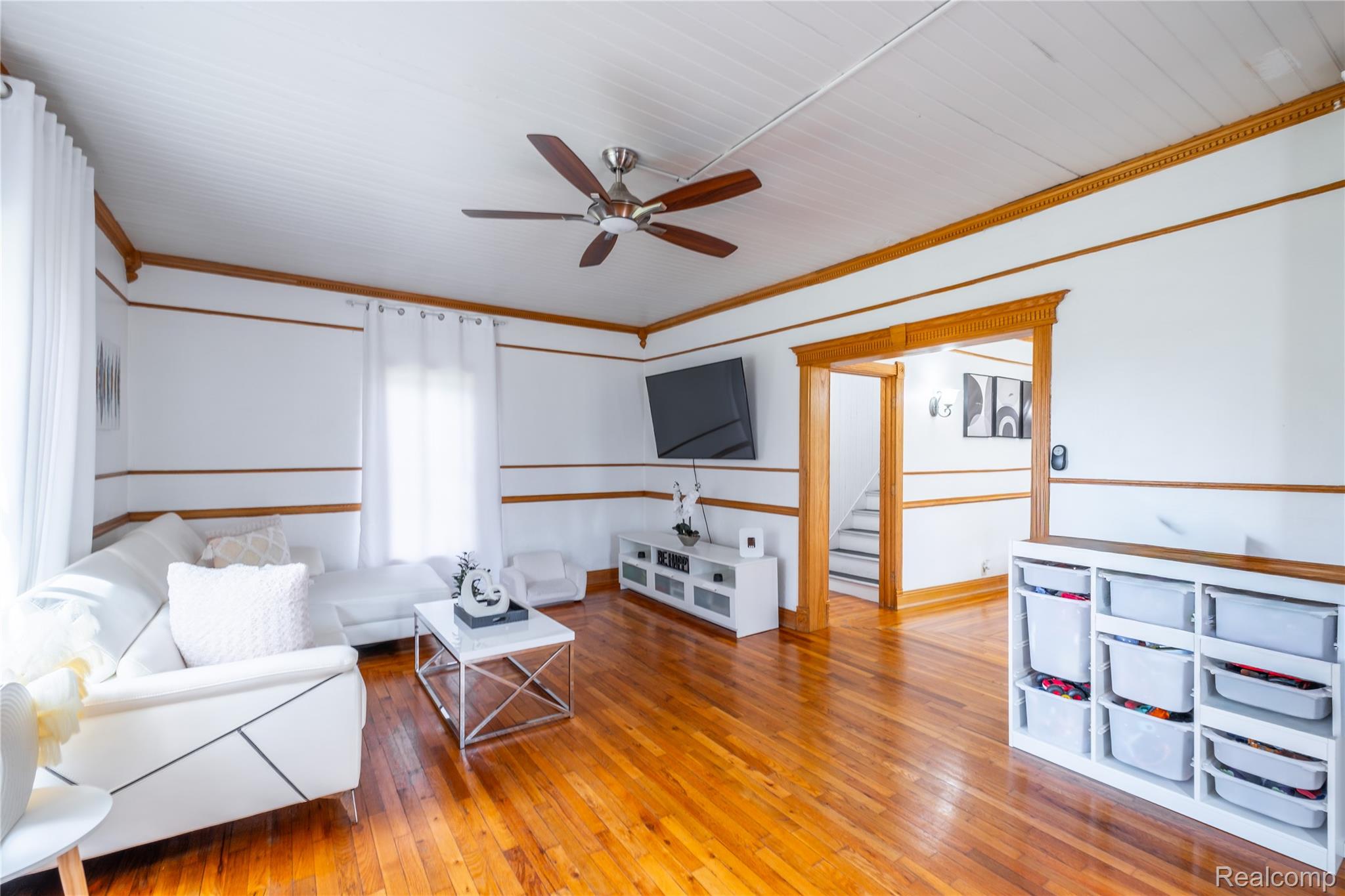 12164 Miller Road Lennon, MI 48449 - Photo 16 of 35 Living room with light wood-style floors, ceiling fan, and ornamental molding