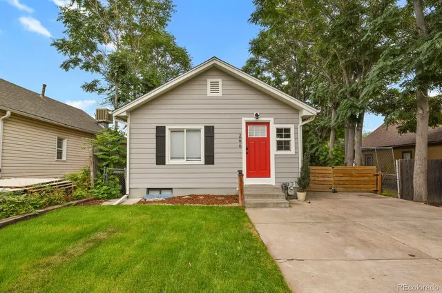 a view of a house with a yard and sitting area