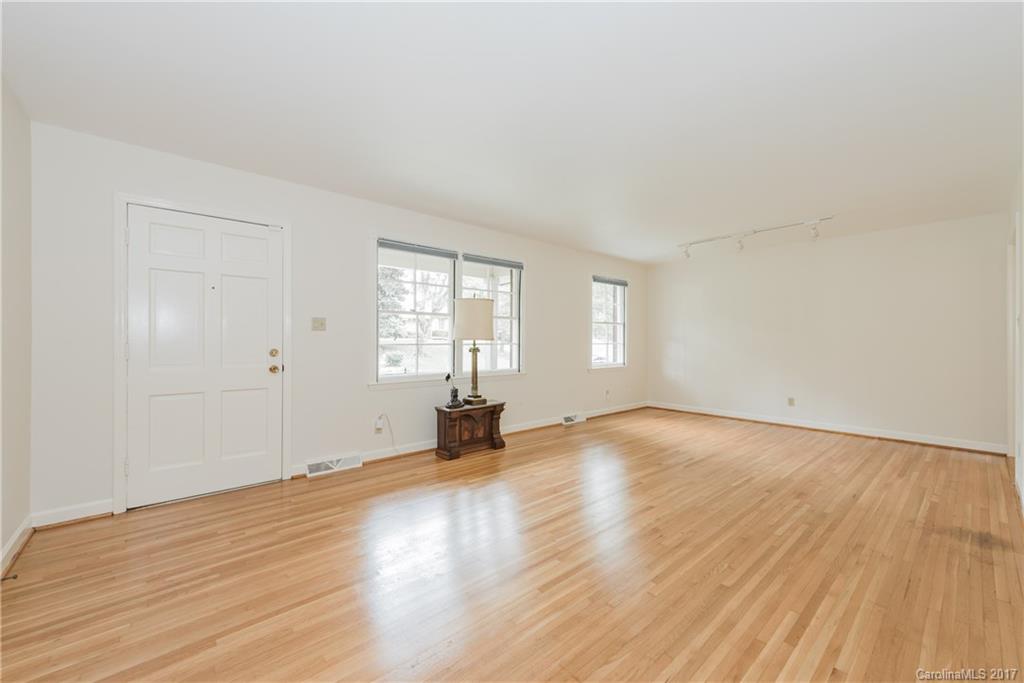5423 Londonderry Road Charlotte, NC 28210 - Photo 2 of 16 an empty room with wooden floor and windows