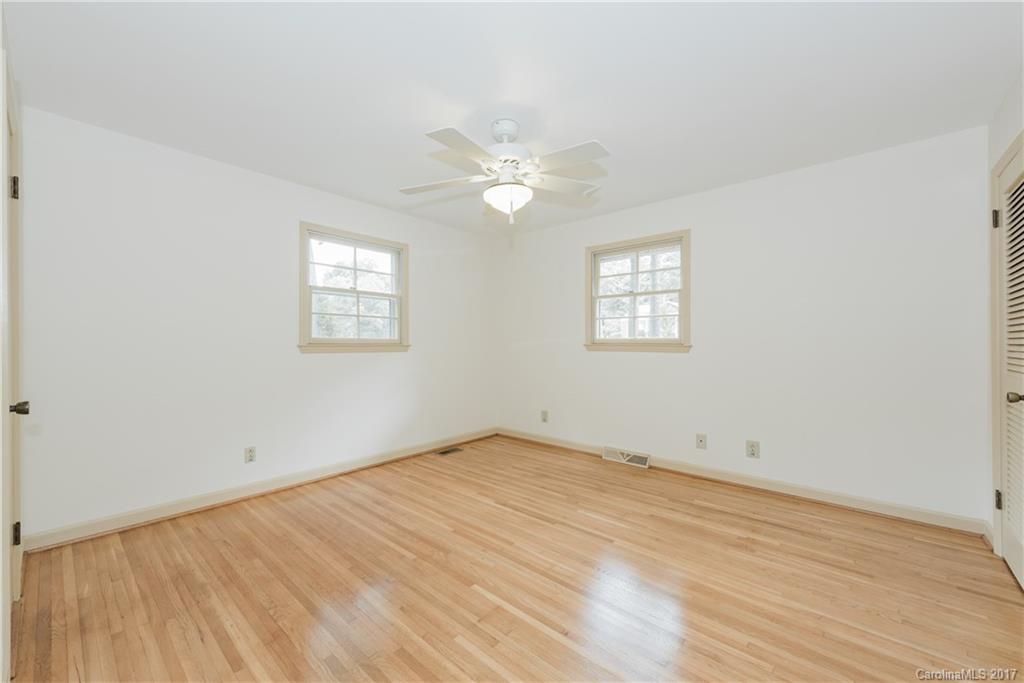 5423 Londonderry Road Charlotte, NC 28210 - Photo 11 of 16 an empty room with wooden floor and windows