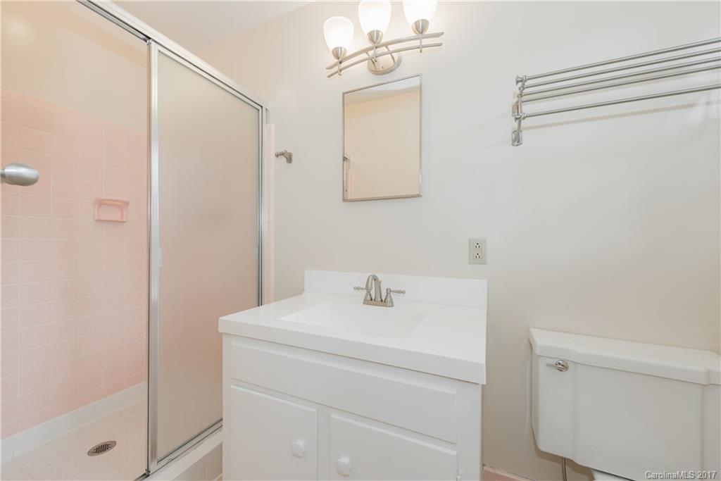5423 Londonderry Road Charlotte, NC 28210 - Photo 12 of 16 a bathroom with a sink a mirror and shower