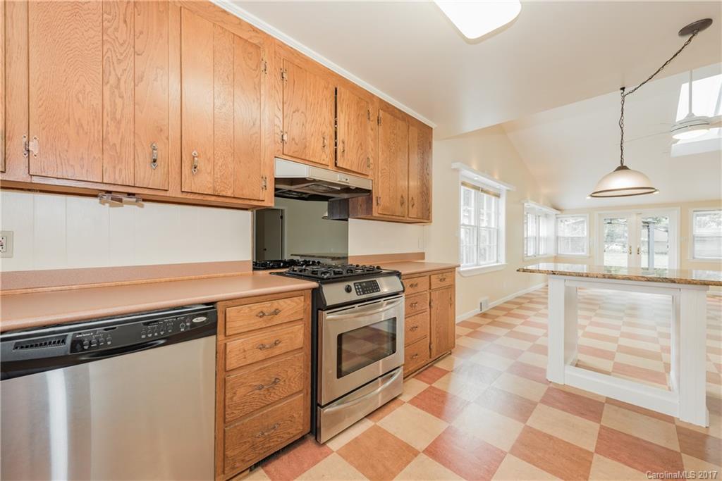 5423 Londonderry Road Charlotte, NC 28210 - Photo 6 of 16 a kitchen with stainless steel appliances granite countertop a stove and a white cabinets