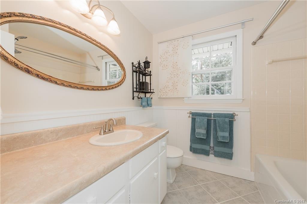 5423 Londonderry Road Charlotte, NC 28210 - Photo 10 of 16 a bathroom with a sink a toilet and a mirror