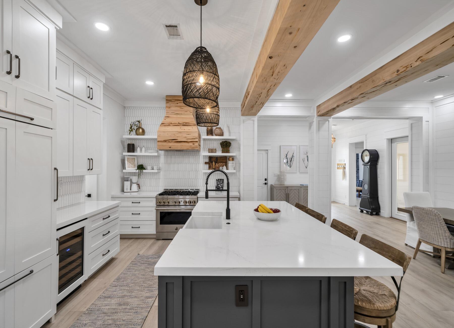 a large kitchen with stainless steel appliances a stove center island and cabinets