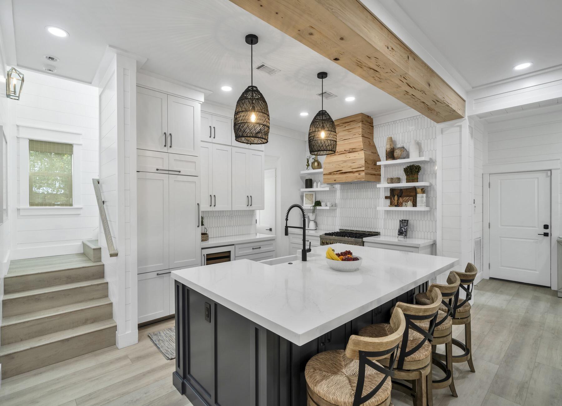 172 Baird Road Santa Rosa Beach, FL 32459 - Photo 11 of 46 a kitchen with a sink a stove and chairs with wooden floor