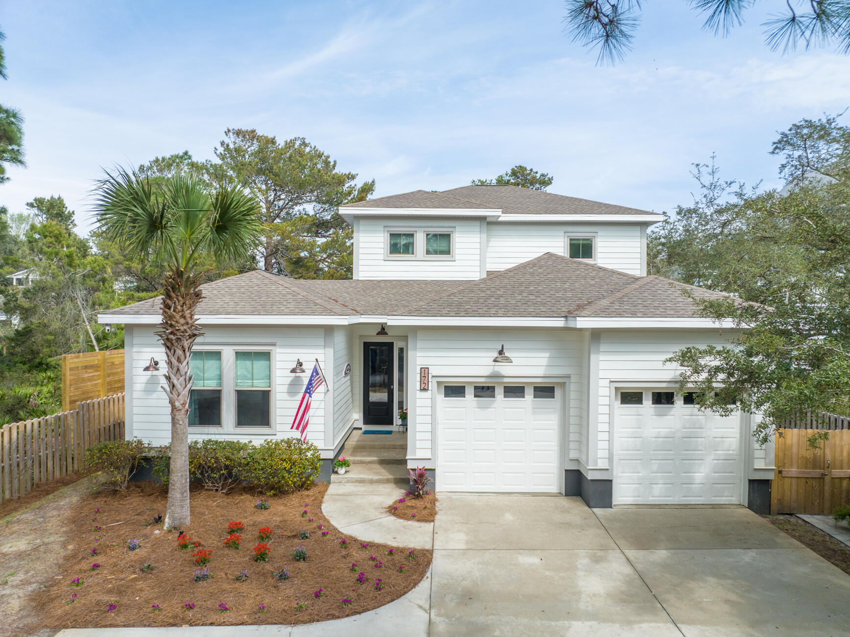 172 Baird Road Santa Rosa Beach, FL 32459 - Photo 29 of 46 a view of a white house with large windows and plants