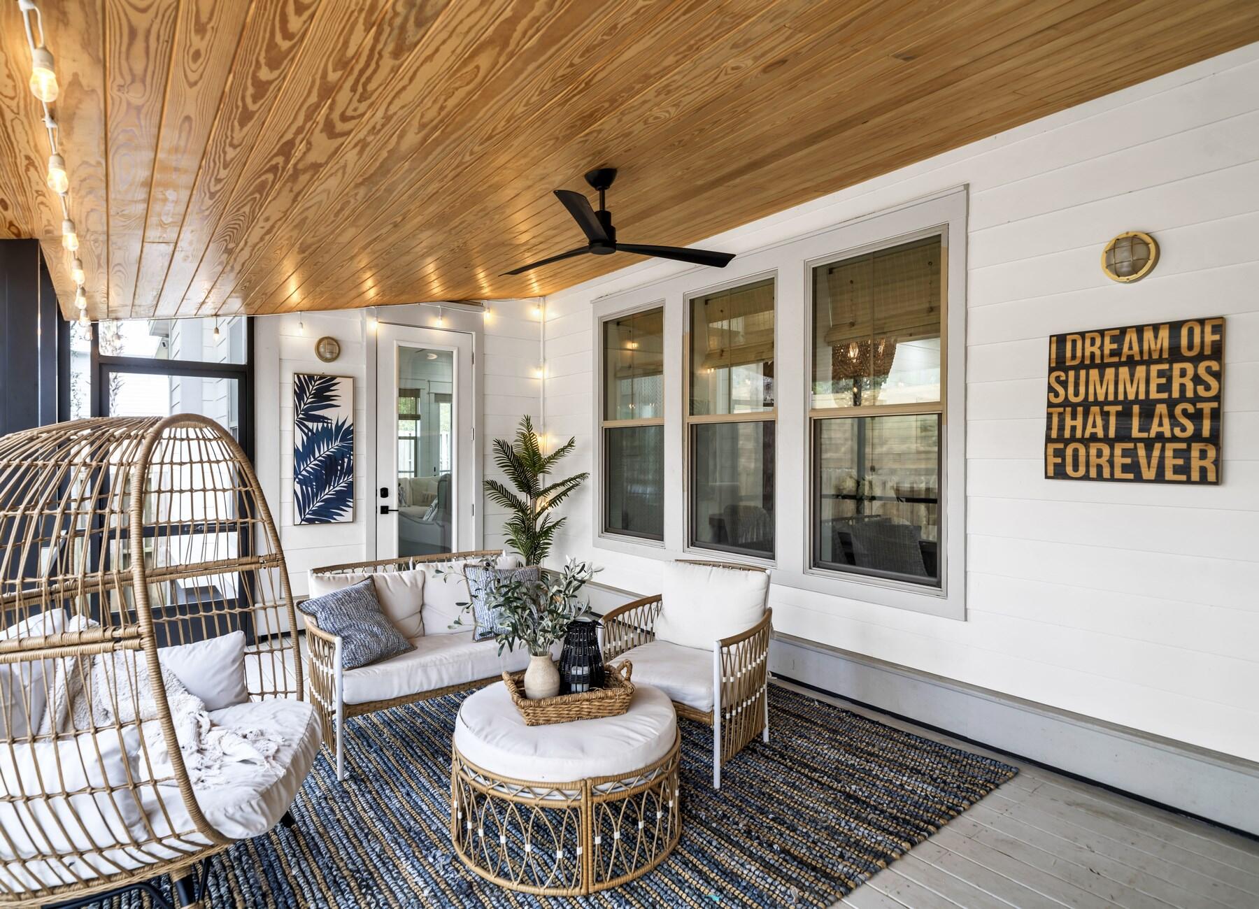 172 Baird Road Santa Rosa Beach, FL 32459 - Photo 31 of 46 a view of a patio with couches table and chairs and potted plants