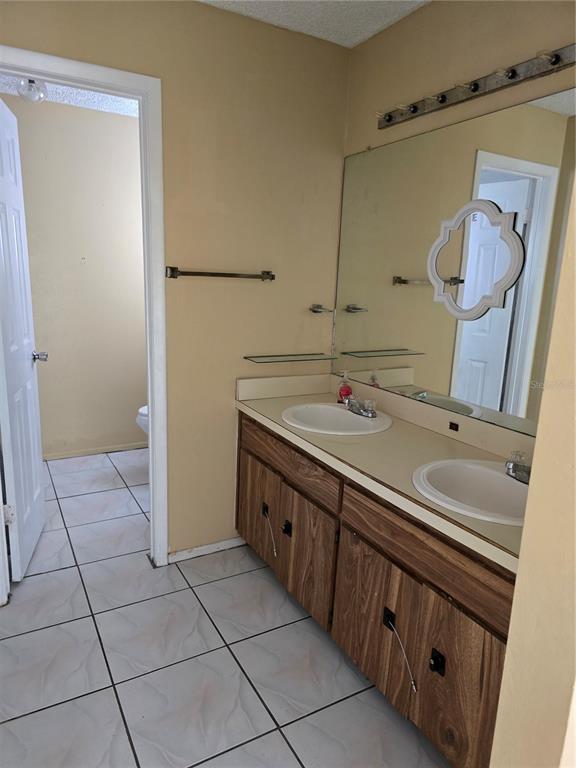 710 Stillview Circle Brandon, FL 33510 - Photo 2 of 5 a spacious bathroom with a double vanity sink a mirror and a shower